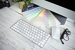Color palette guide on white background,Focus exclusively on ,table working on laptop
