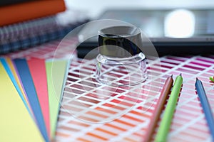 Color palette with shades of magnifying glass and pencils lie on table closeup