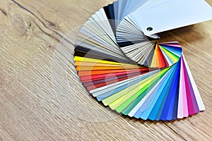 Color palette swatches. Palette of different colors and shades on wood background. Color catalog for tinting facade and interior