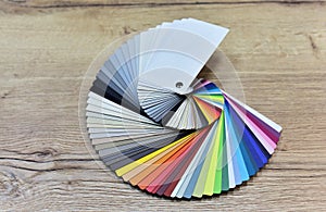 Color palette swatches. Palette of different colors and shades on wood background. Color catalog for tinting facade and interior