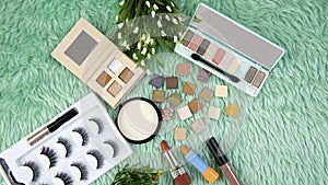 The Color of palettes Makeup professional cosmetics on green fur background,Spring collection image