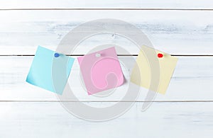 Color paper note with pin on old wood background