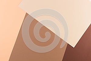 Color papers geometry composition background with pink, beige and brown tones.