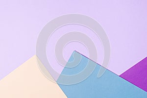 Color papers geometry flat composition background with violet,blue, lilac, beige.