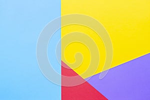 Color papers geometry flat composition background with yellow red blue and purple tones