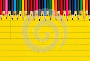 Color pencils crayons on vintage yellow ruled line notebook paper