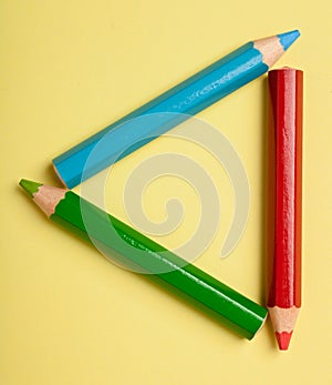 Color pencils forming a triangle frame