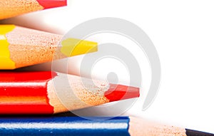 Color pencils isolated on white background, macro view.