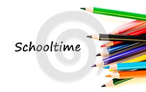 Color pencils isolated on white background. Text schooltime.