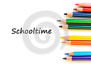 Color pencils isolated on white background. Text schooltime.