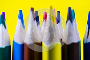 Color pencils isolated on yellow background.Close up