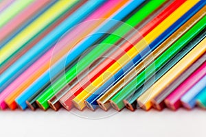 Color pencils laid out in a row on a white background