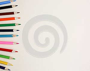 Color pencils lying on pastel beige background. Back to school concept. Colorful art studying and painting process. Drawing with