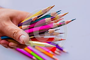 Color pencils over white background close up