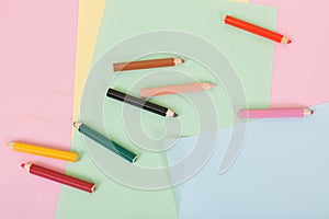 Color pencils and paper on children desk