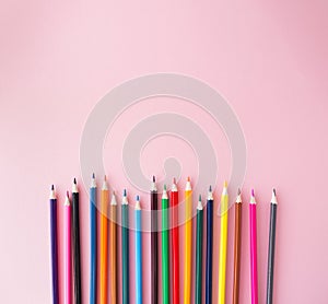 Color pencils on pink background close up with Clipping path..Color pencils for drawing Rainbow. Copypaste, flat lay