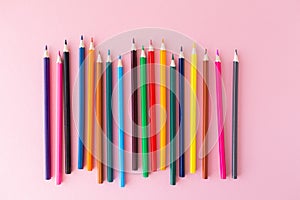 Color pencils on pink background close up with Clipping path..Color pencils for drawing Rainbow. Copypaste, flat lay