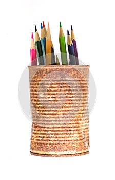 Color pencils in rusty tin can