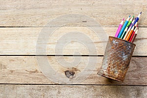 Color pencils in rusty tin can