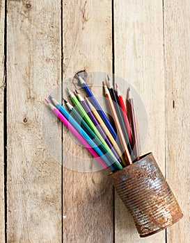 Color pencils in rusty tin can