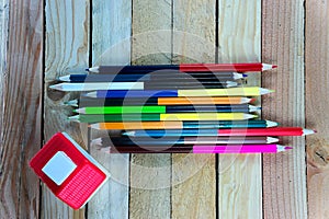 Color pencils and small house on wooden table see on top view