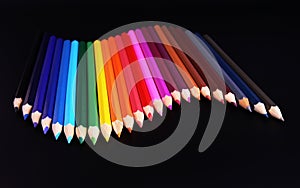 Color pencils wave isolated on black