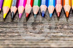 Color pencils on weathered aged pine wood boards close up macro shot,