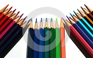 Color pencils on white background pointing upward