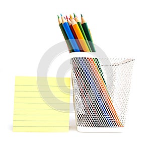 Color pencils in the white meshy box photo