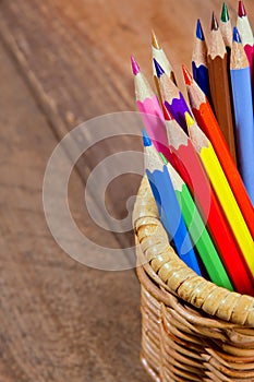 Color pencils on wooden background