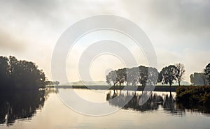 Color photo of a misty autumn morning at the lake