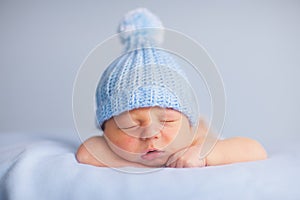 Newborn Baby Boy Sleeping Peacefully in Knit Hat