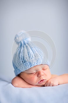 Newborn Baby Boy Sleeping Peacefully in Knit Hat