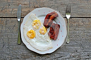 Photography of Breakfast made of fried eggs and bacon photo