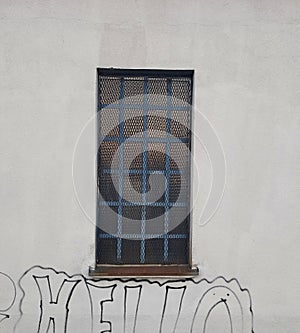 Old gridded window with reinforced glass on industrial building