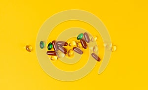 Color Pill Capsules on Yellow Background, Analgesic Pile, Transparent Painkiller Drugs Mix, Sedative Pills