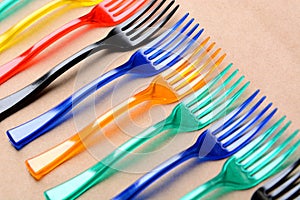 Color plastic forks on paper background