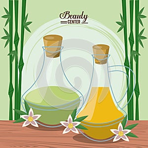 Color poster of beauty center with bamboo plant background and set of essences bottles