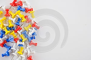 Color push pins red, yellow, white, and blue group on the left of white background