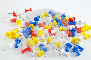 Color push pins red, yellow, white, and blue group on white background