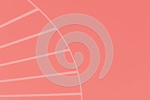 Color salmon background with stripes in a semicircle in the left part of the photo