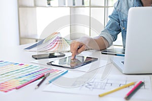 Color samples, colour chart, swatch sample, Graphic designer being selecting Color table and graphics tablet, pen at workplace wi
