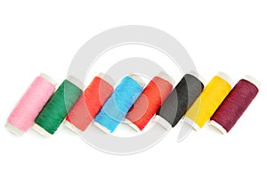 Color sewing threads on white background