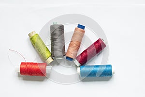 Color sewing threads on white background