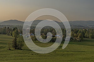 Color sunset with fresh meadows and old buidlings near Trojanovice village