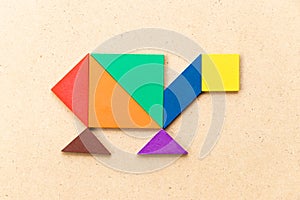 Color tangram in turtle, terrapin or tortoise shape on wood background