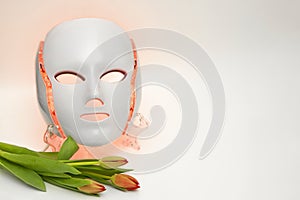 Color therapy mask glowing red with tulips