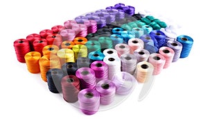 Color threads and sewing accessories on white background