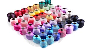 Color threads and sewing accessories on white background