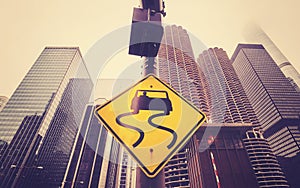 Color toned slippery road sign with Chicago skyscrapers.